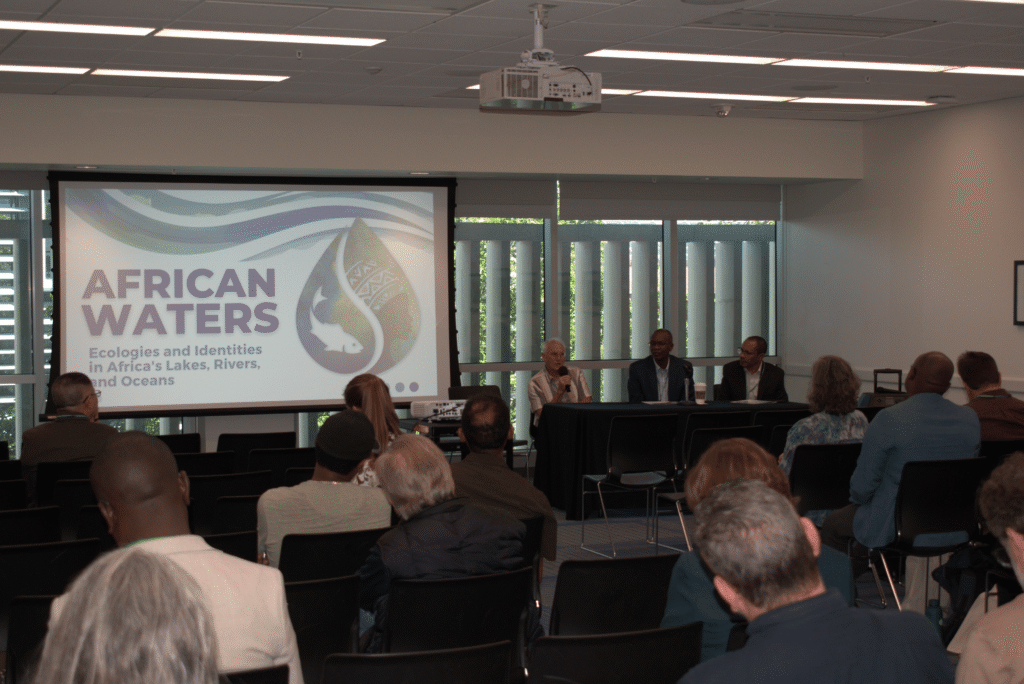 A group of people facing speakers at the Carter Conference.
