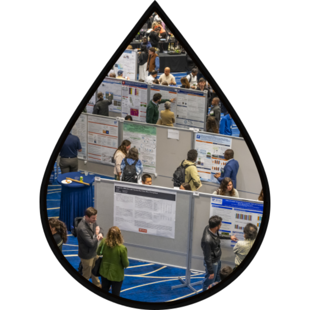 People presenting posters at the Water Institute Symposium in the cutout of a droplet.